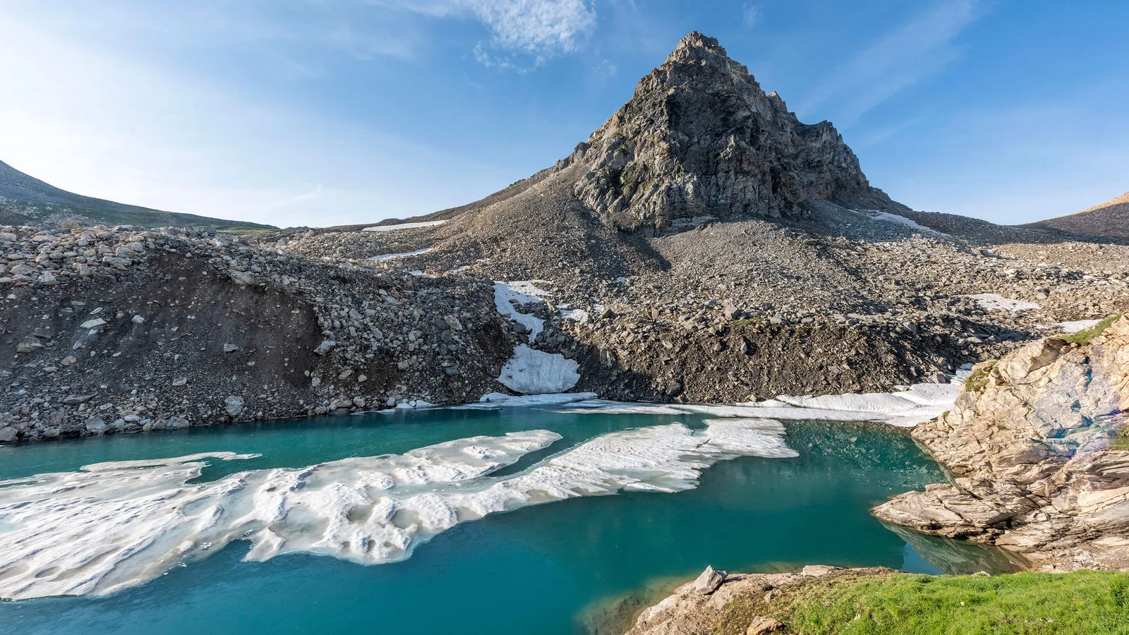 Blick auf einen Bergsee mit Eisschollen